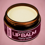 Jar of cherry vanilla lip balm with a pink label on a pink background