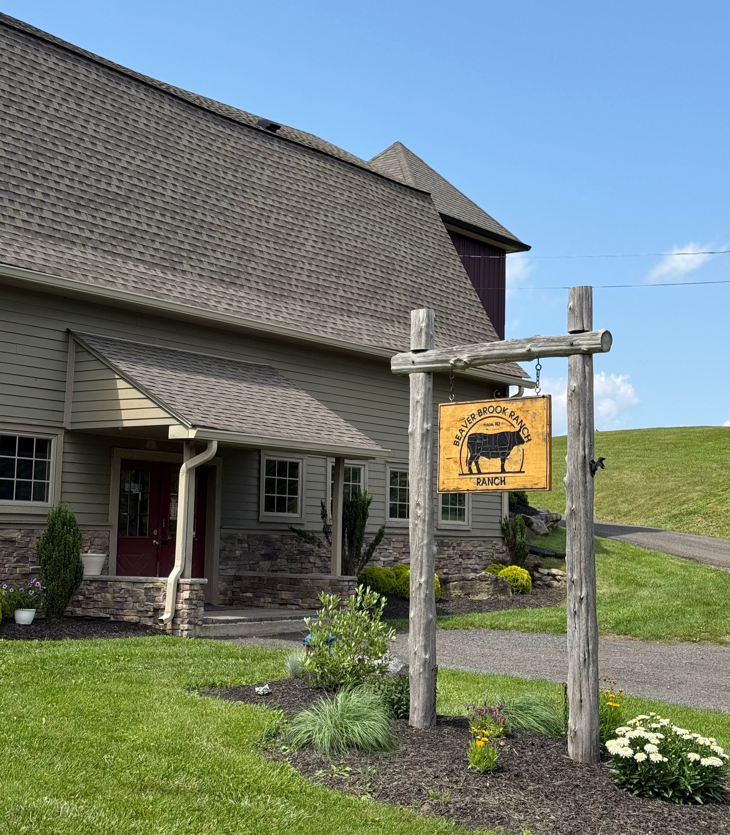 Rancher's Render Farm Store Main Location with Wooden Sign Hanging out front