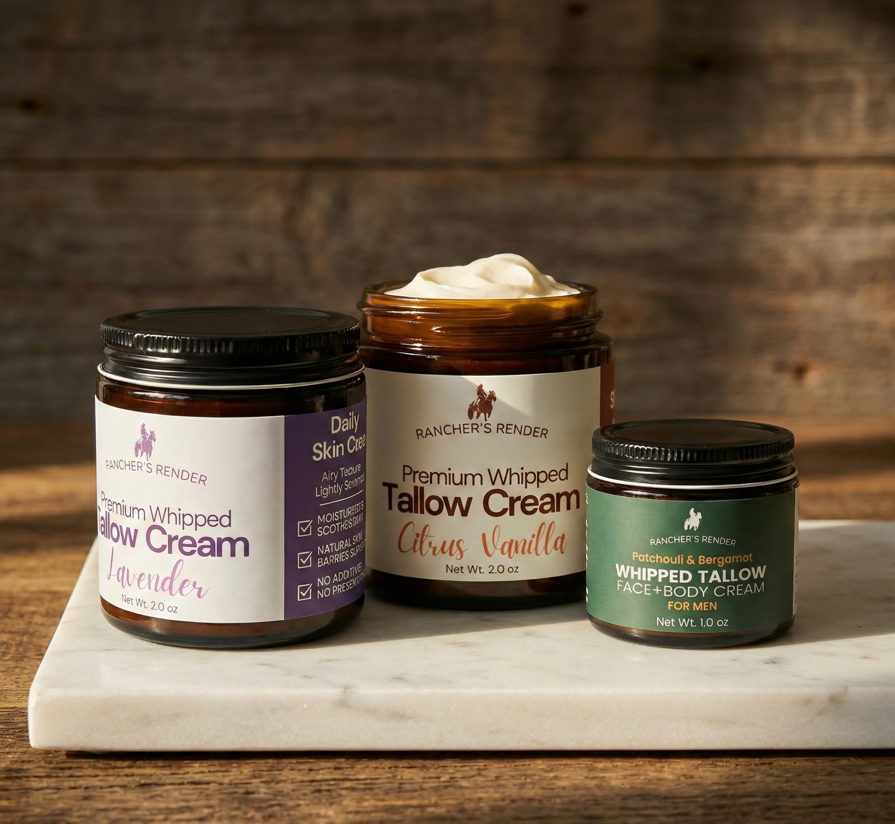 Three jars of tallow cream on a marble slab with a wooden background